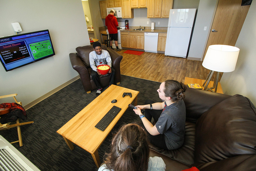 Students in shared living spaces in a dorm suite.