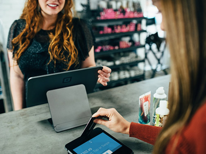 Credit card transaction with smiling sales associate