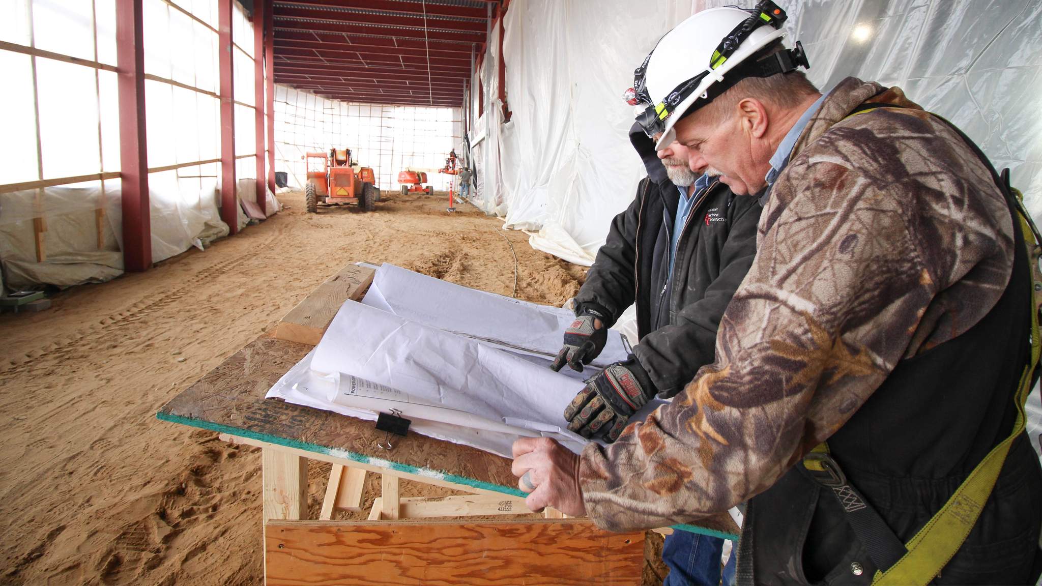 Construction Workers Looking at Plans