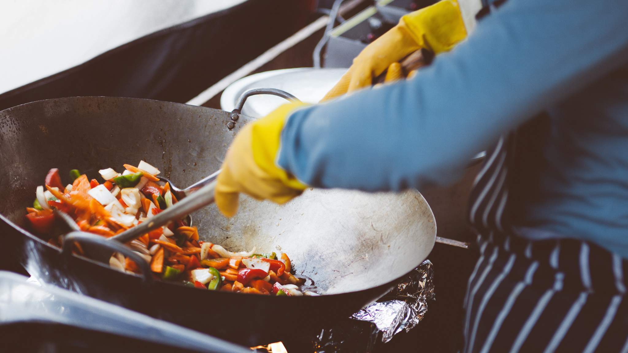 Person cooking with gloves on