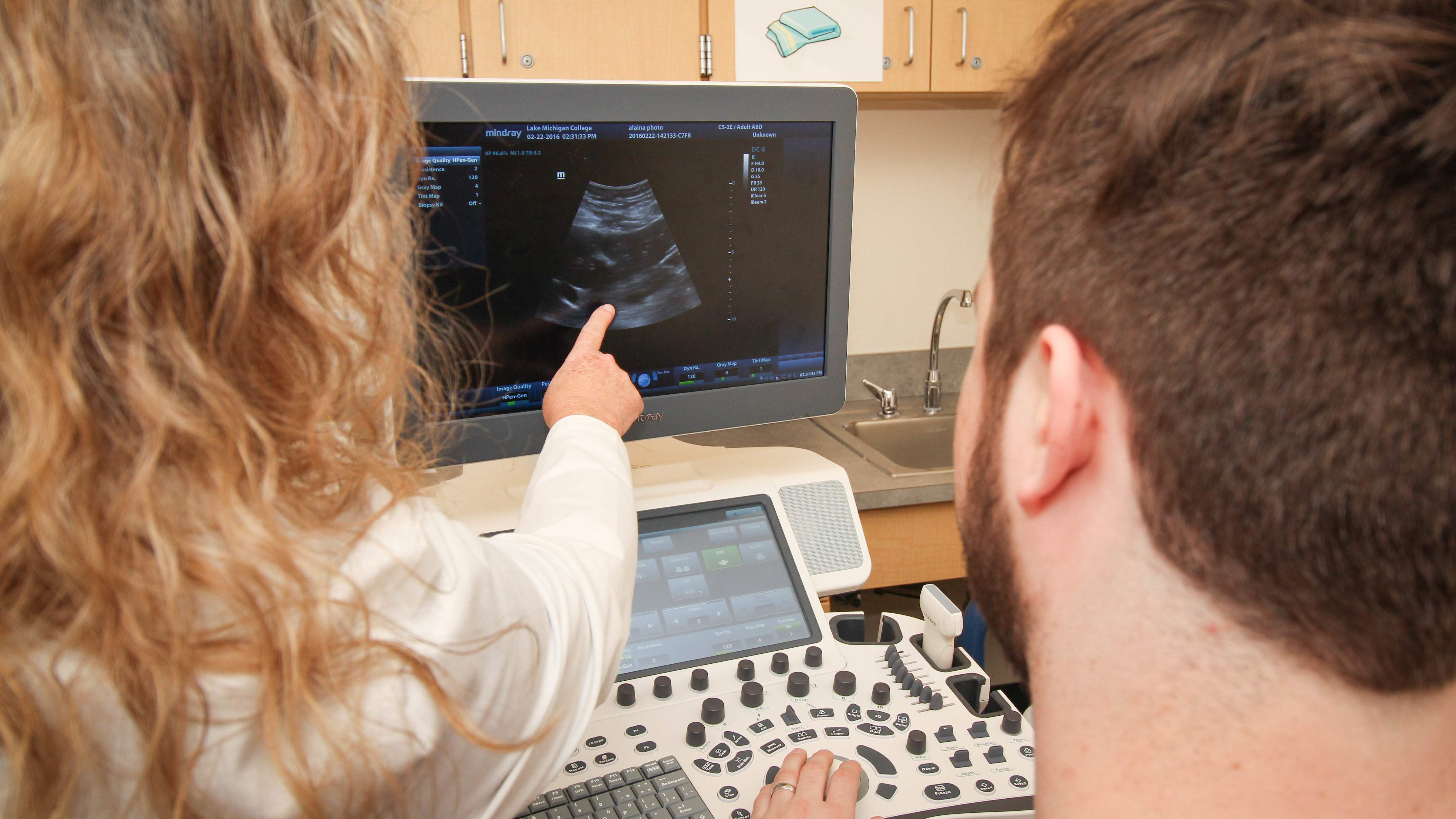Instructor and student reviewing ultrasound
