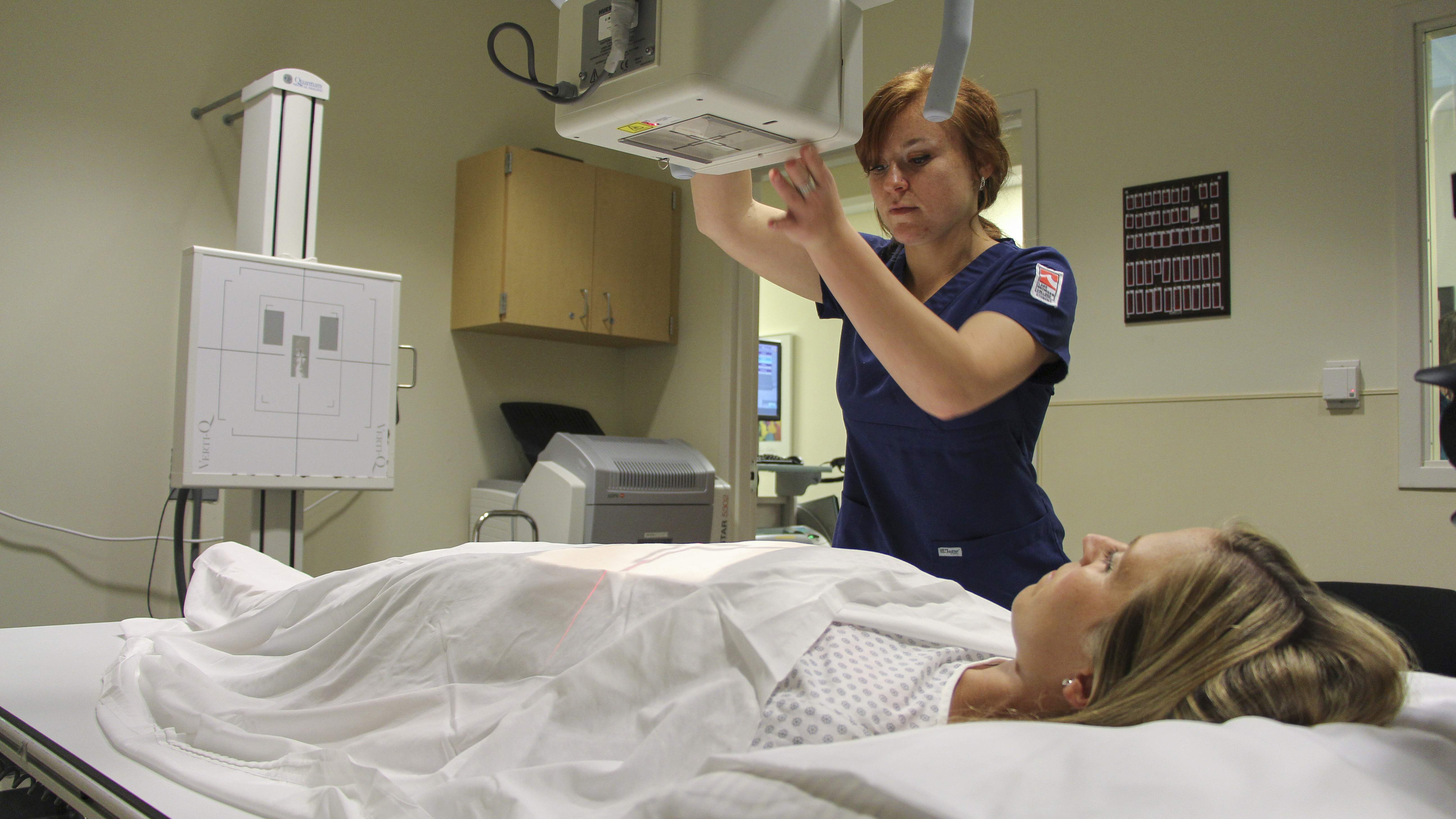 Rad tech student practicing in the x-ray lab