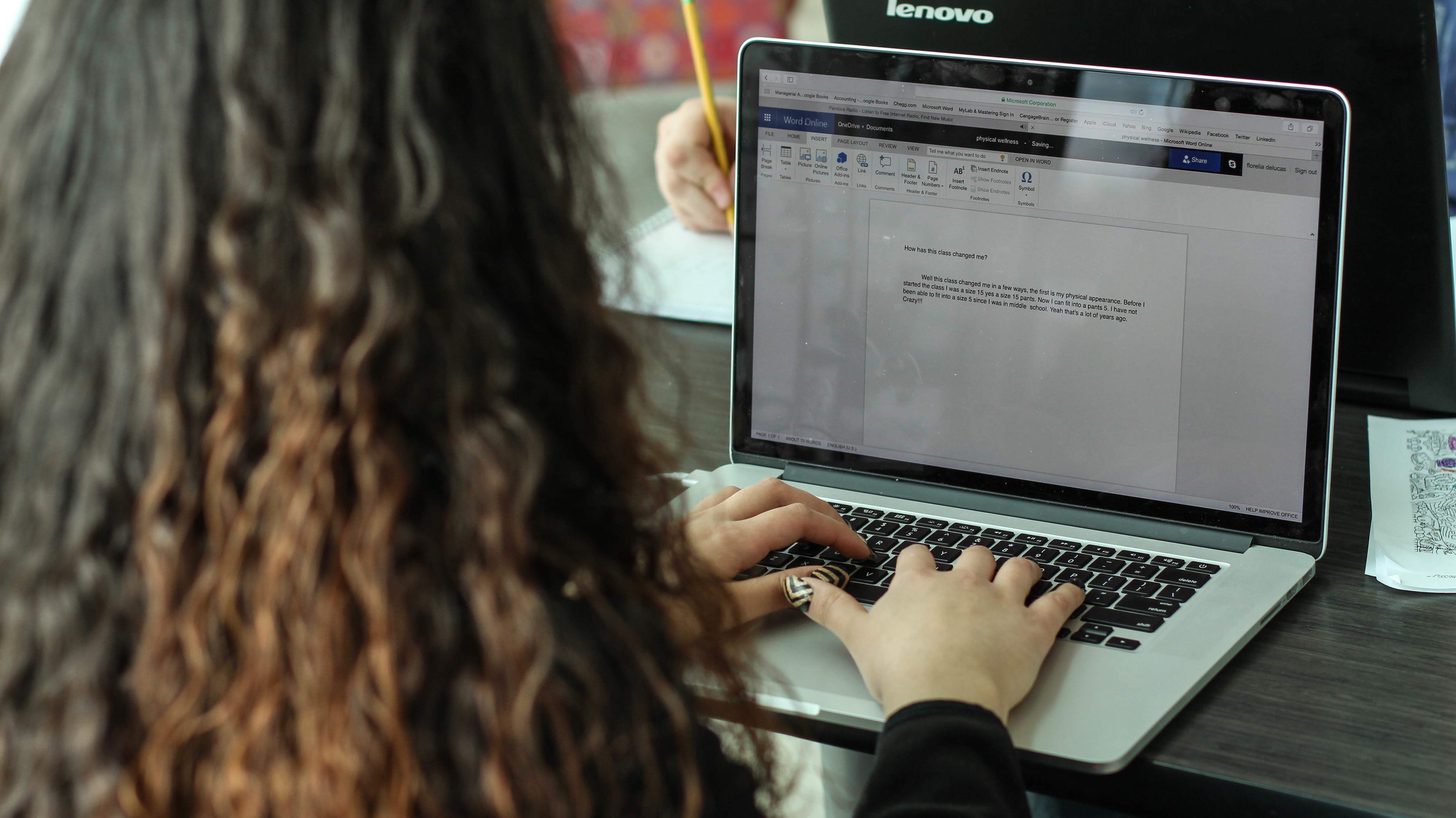 Student working on an essay on a laptop