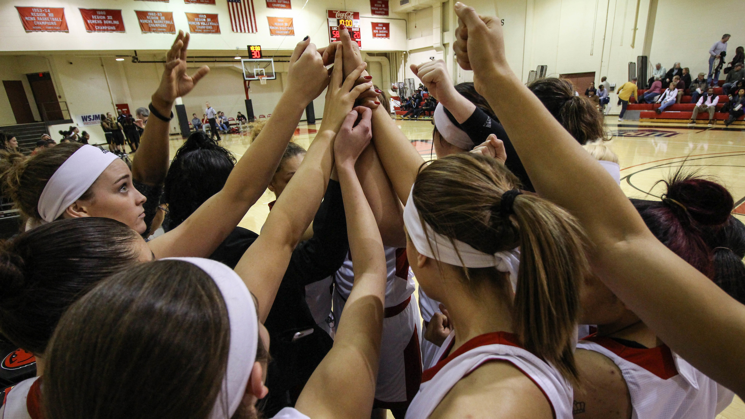 Redhawks Basketball team in a huddle