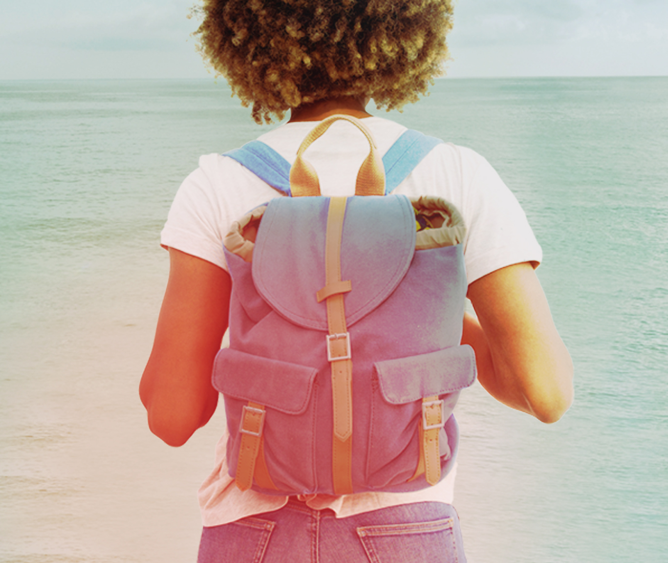 Women with backpack looking at Lake Michigan