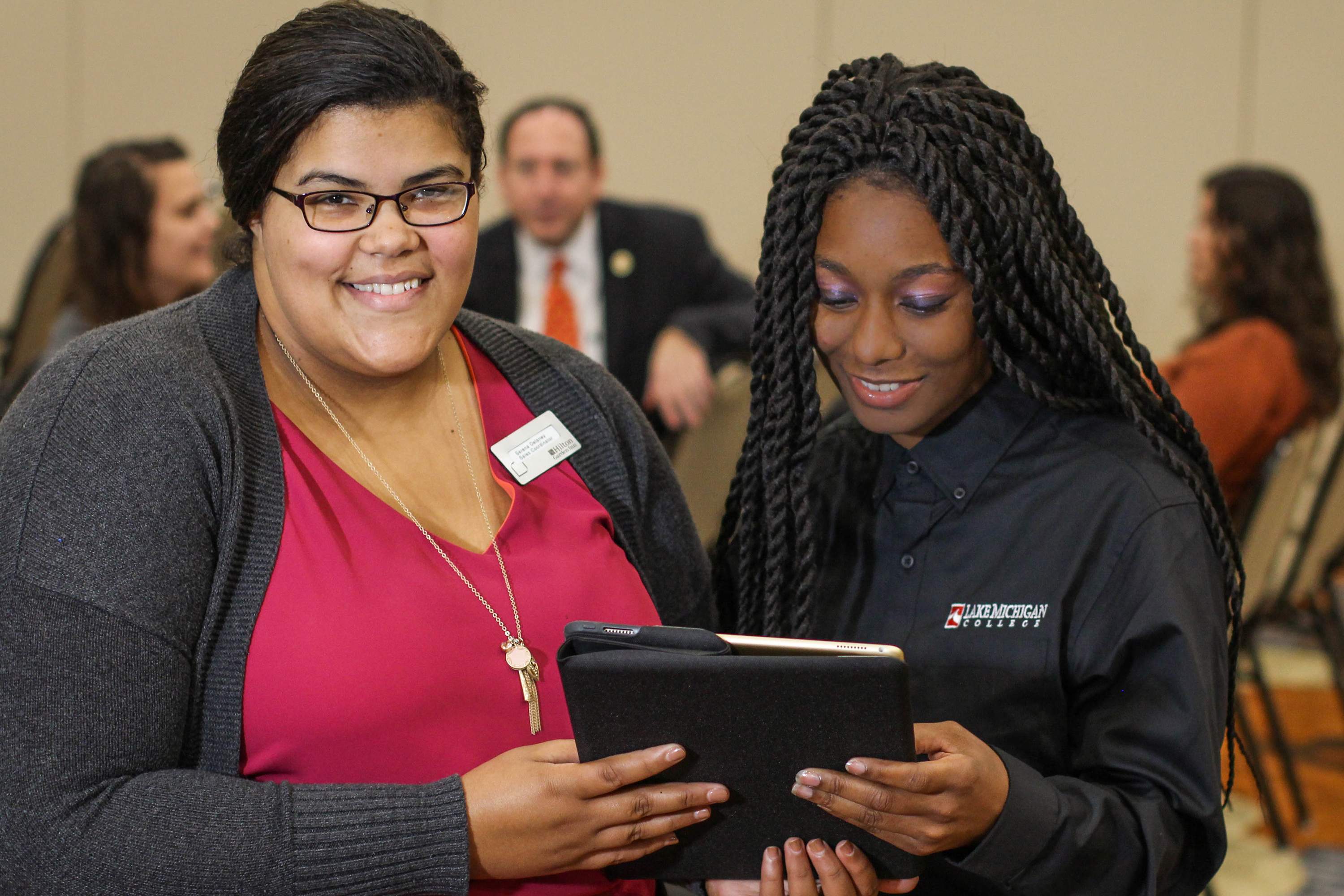 LMC alumna talking with a student