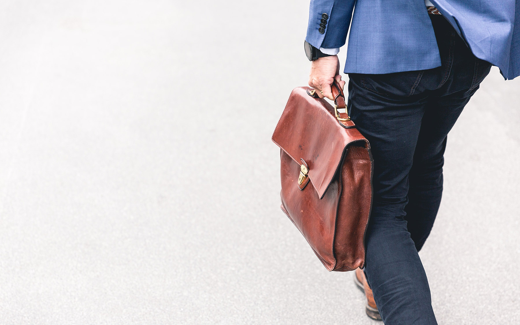 Person walking with a briefcase