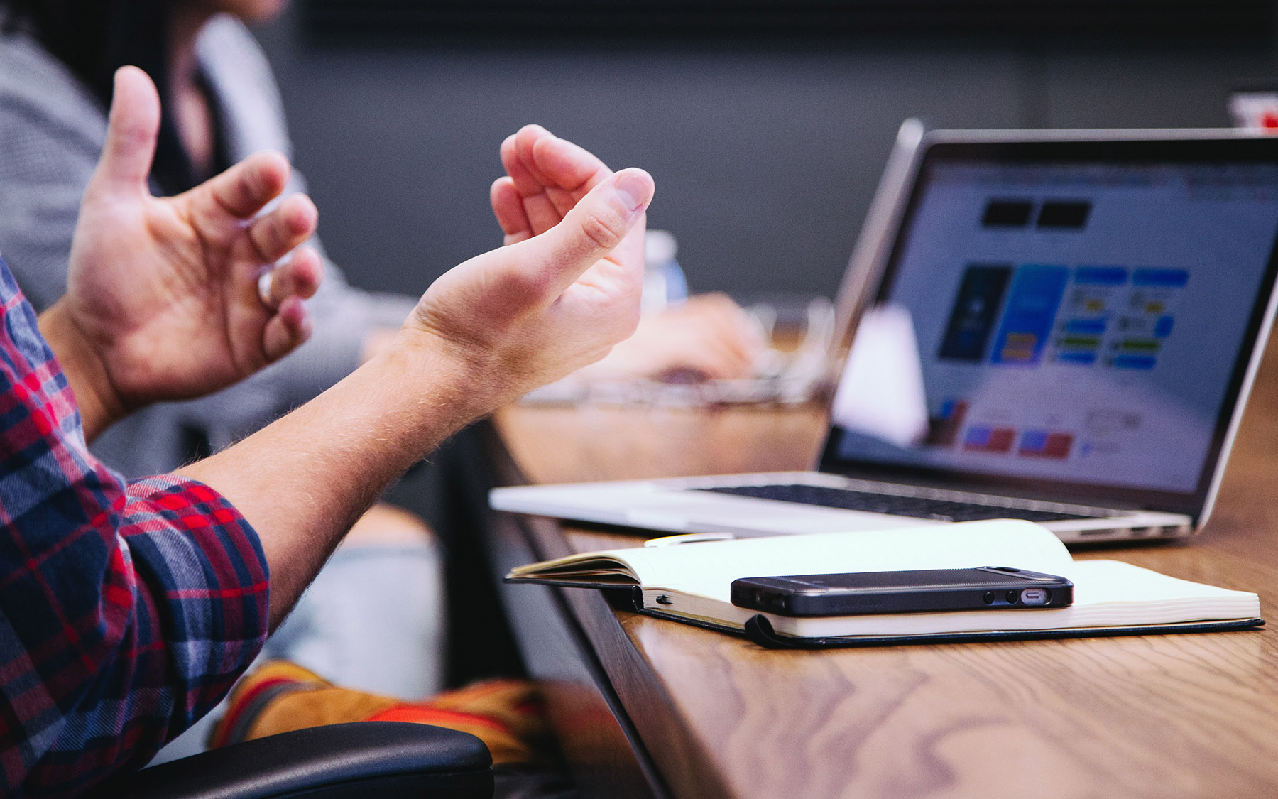 People in a discussion at a conference table