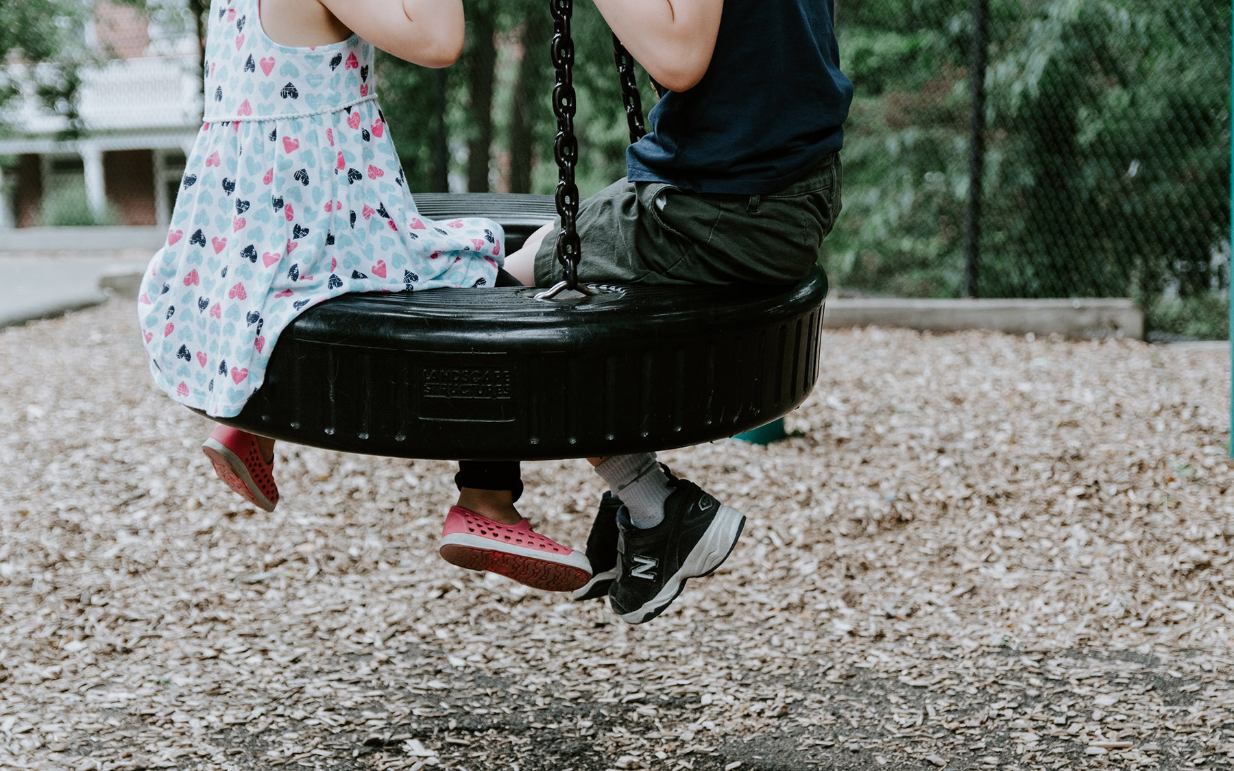 Children playing on a tire swing