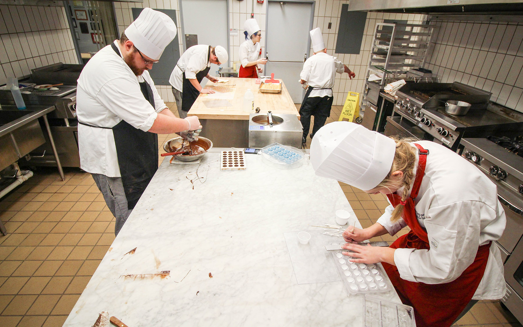 Students working with chocolate in the teaching kitchen.