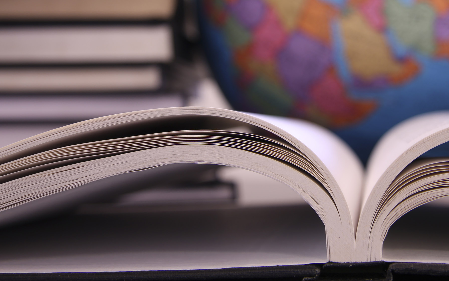 Open book in front of a globe