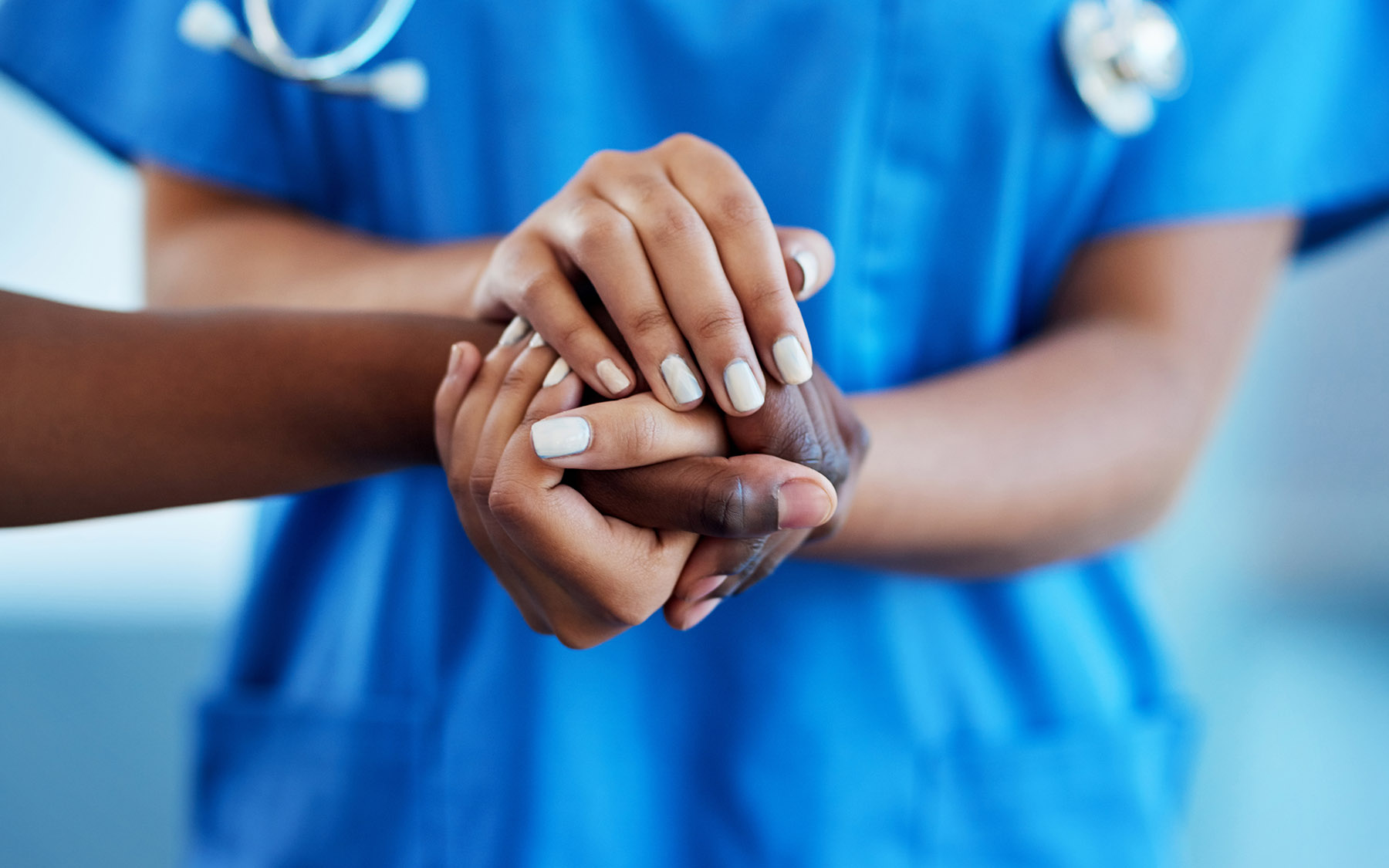 Health professional holding someone's hand