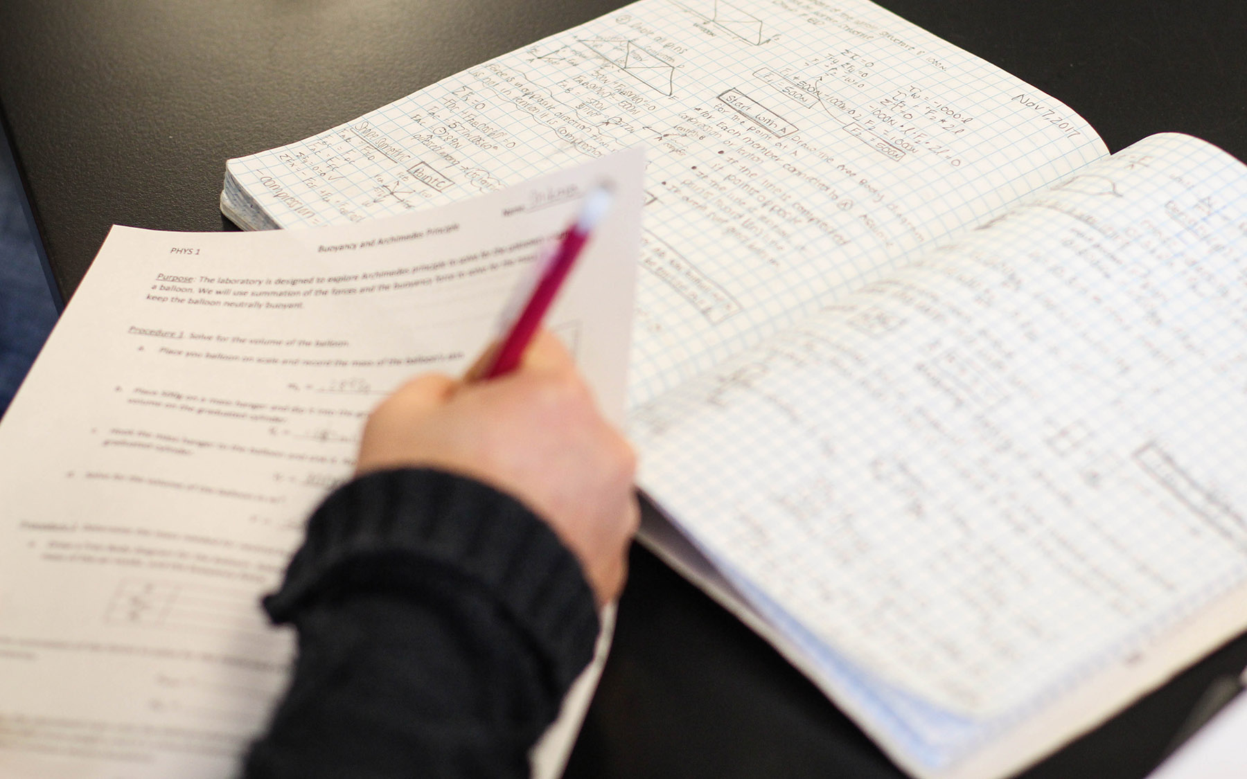 Student taking notes in class