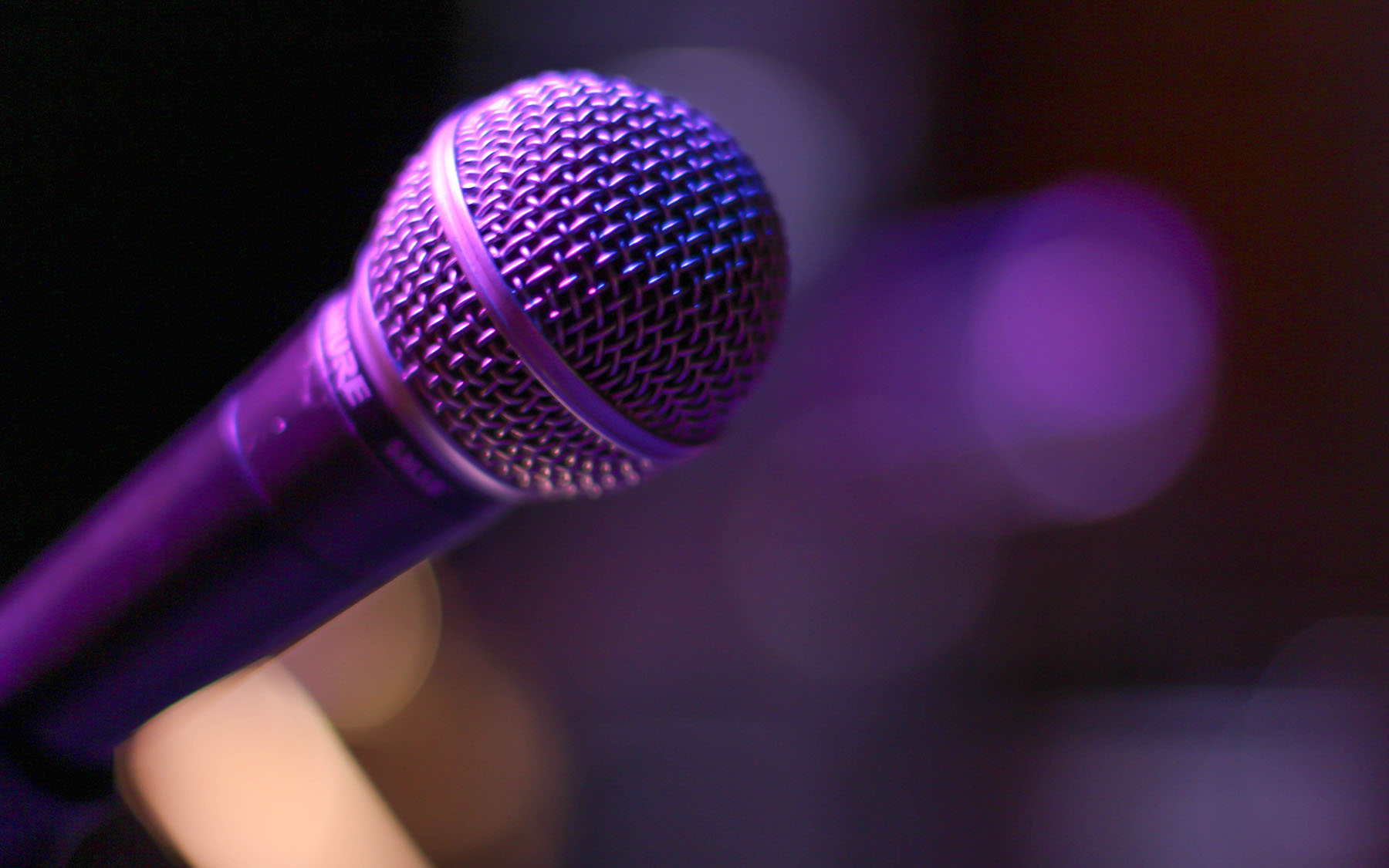 Microphone on stage with purple light
