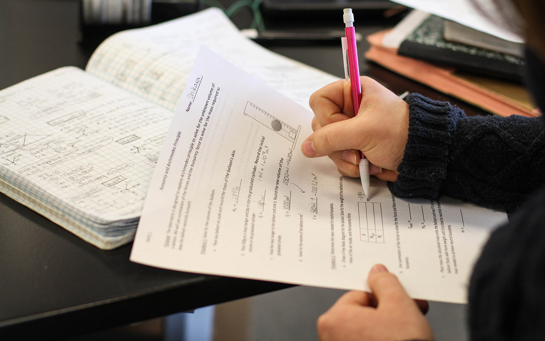 Student taking notes in a science lab