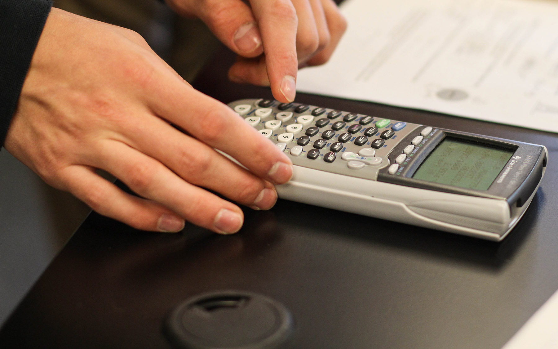 Student using a scientific calculator