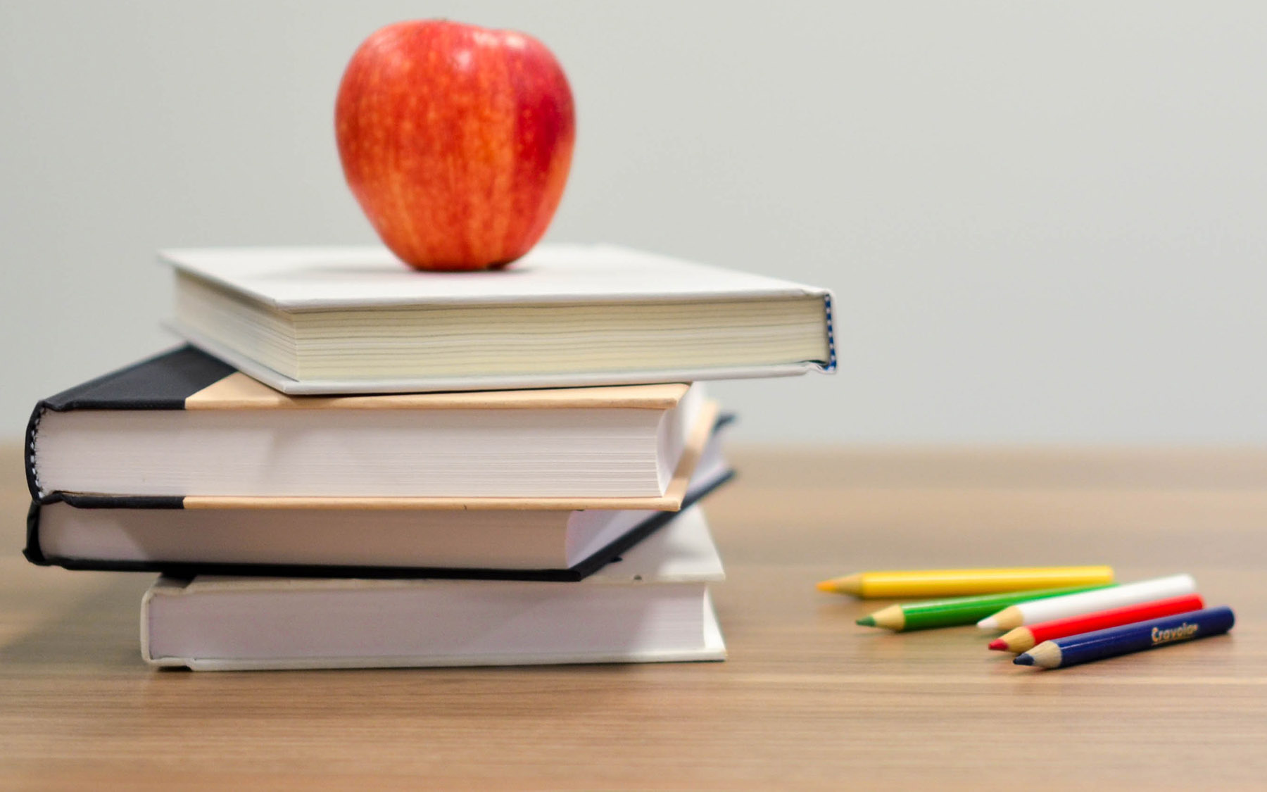 Apple with books on a desk