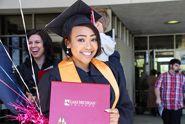 Student with diploma after commencement.