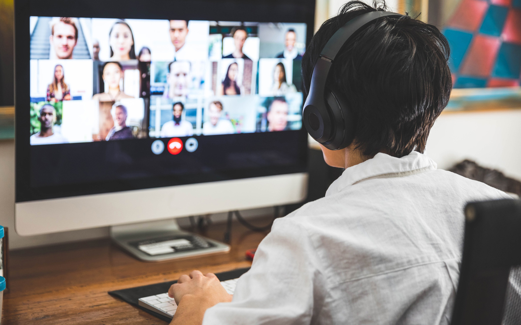 Person wearing a headset participates in a virtual meeting.