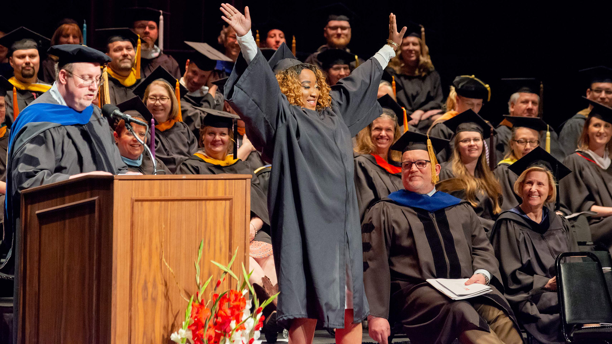 Graduate celebrates after commencement.