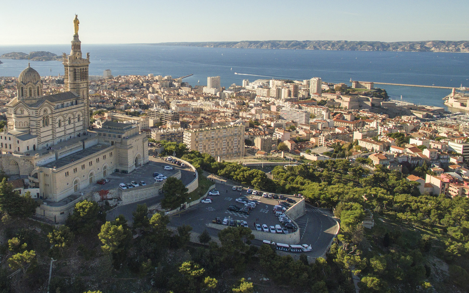 High angle view of Notre Dame de la Garde in Marseille near the sea against clear sky. 