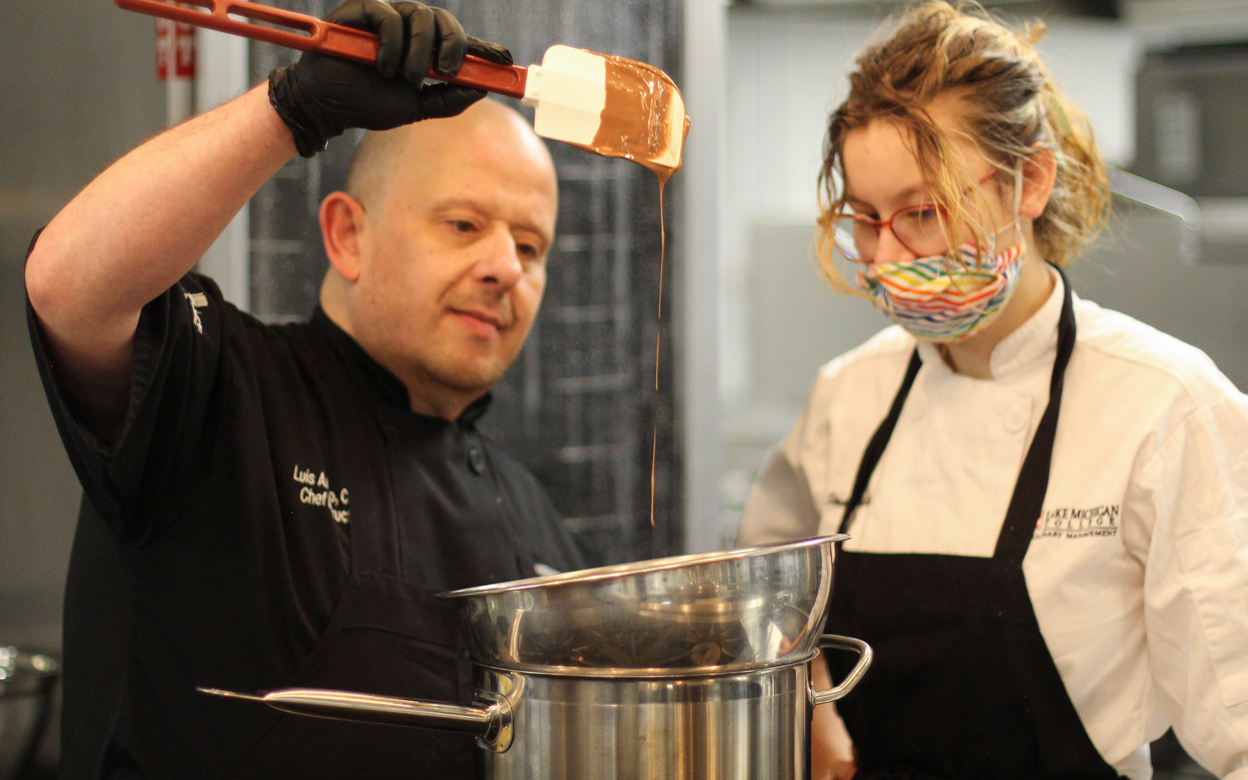 Chef Stirring chocolate with a student.