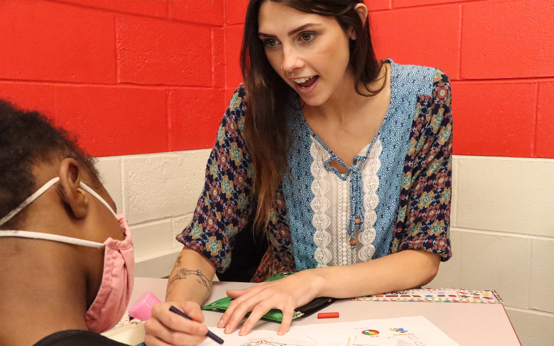 A behavioral technician speaking with a client.