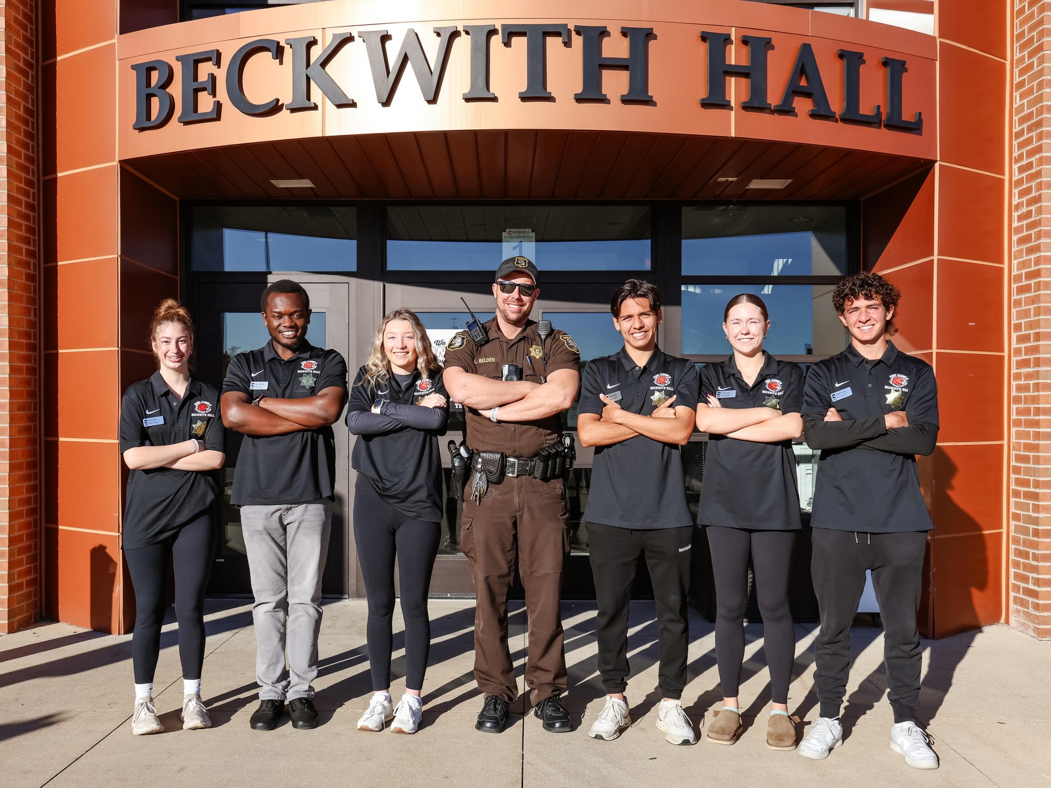 Proud campus police and supporters standing in front of Beckwith Hall