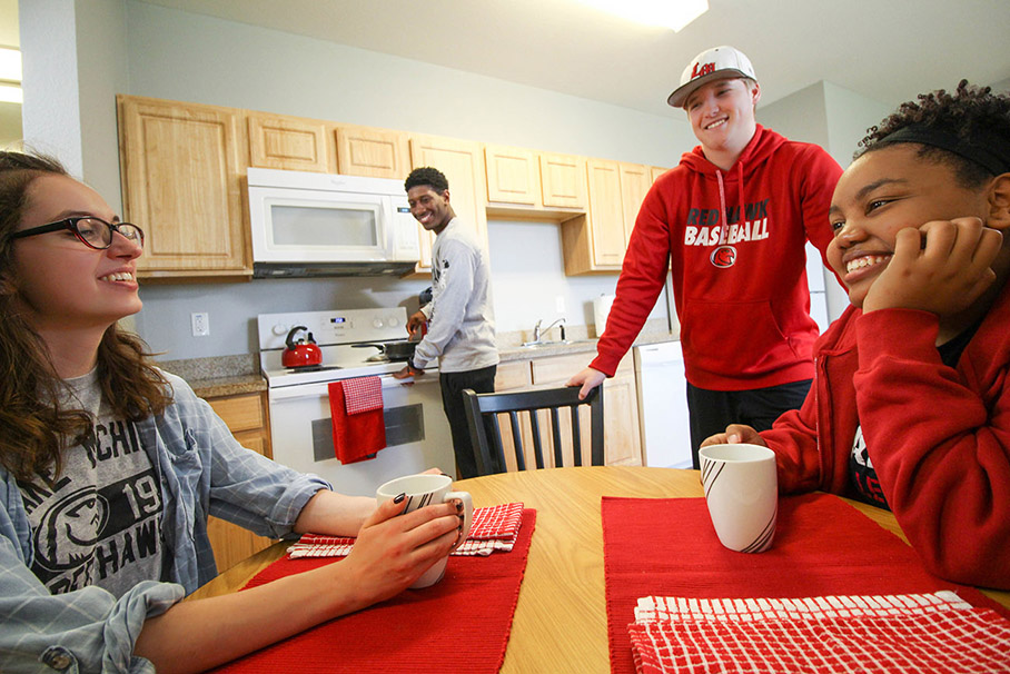 Students talking in a dorm room kitchen