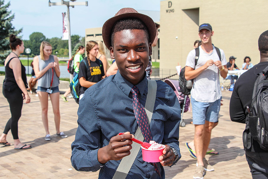 Student enjoying a snack at a student life event