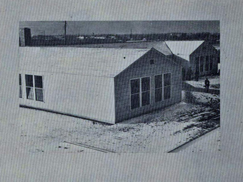 Spare, temporary-looking building or quonset hut.