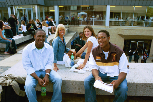 Several students pose in the amphitheater steps in the future site of the Hawk's Nest.