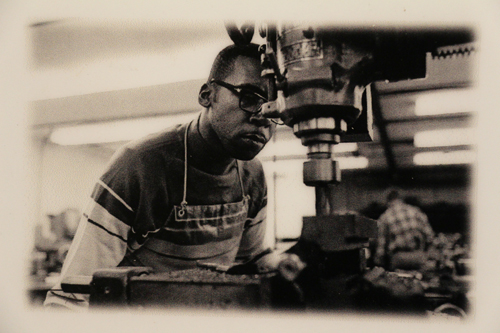 Young man works with a lathe.