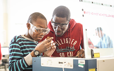 Child and parent working on a project in the Fab Lab.