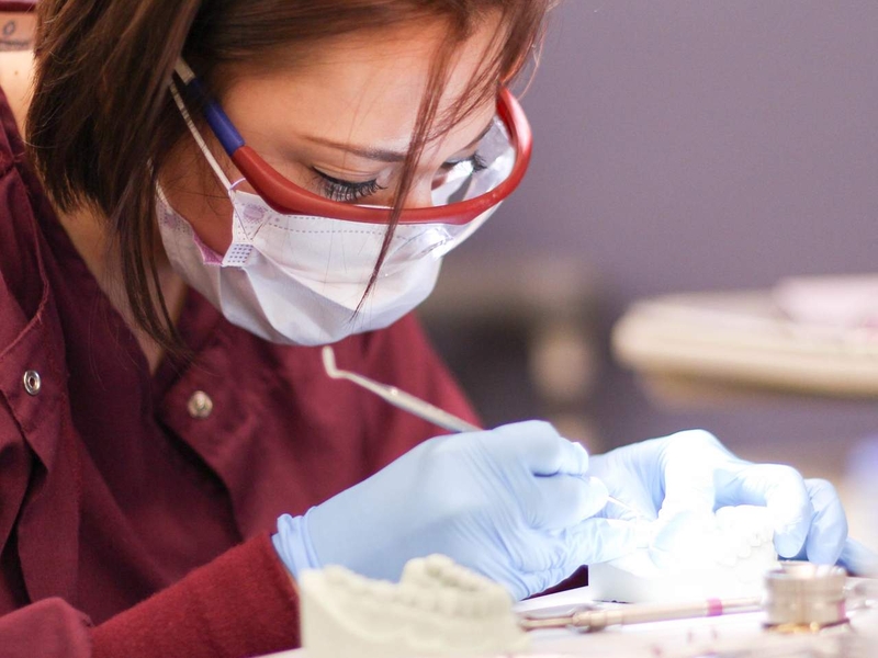 Dental Assistant cleaning a patient's teeth