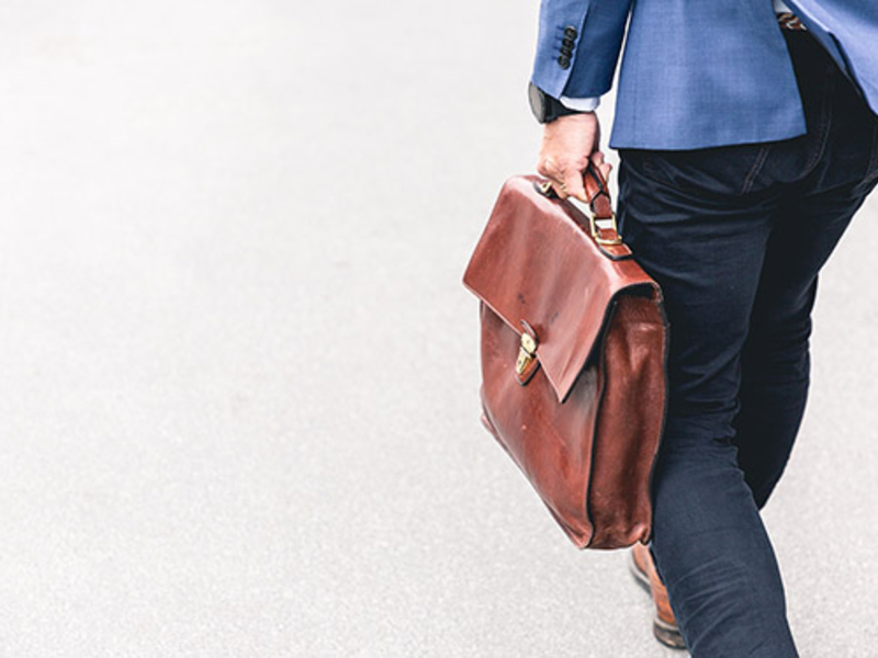 Person walking with a briefcase