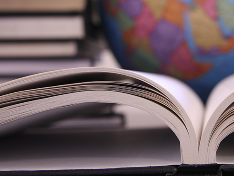 Open book in front of a globe