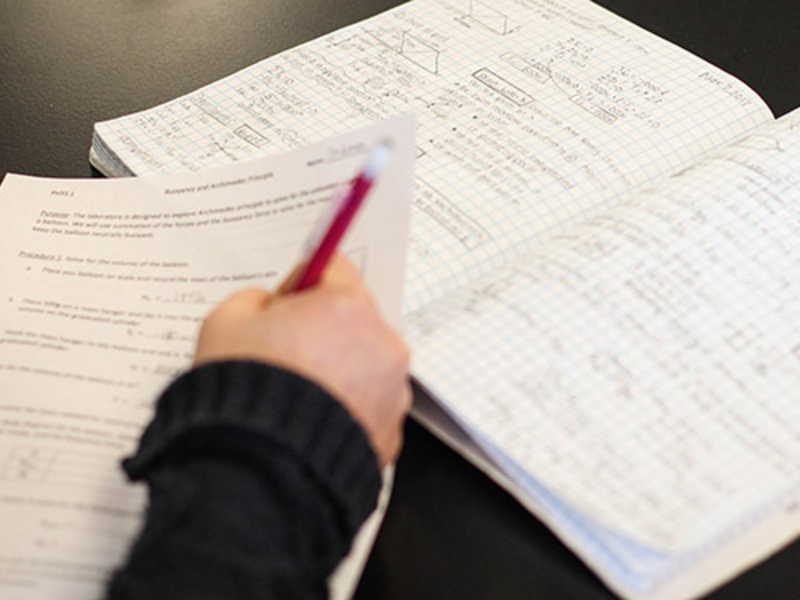 Student taking notes in class