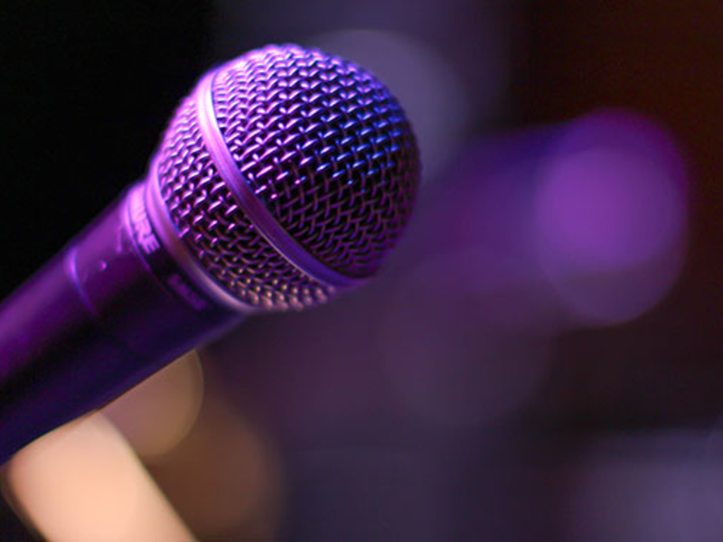 Microphone on stage with purple light
