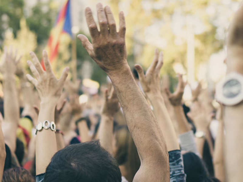 Crowd of people with their hands raised