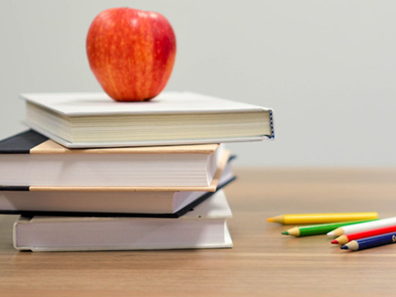 Apple with books on a desk