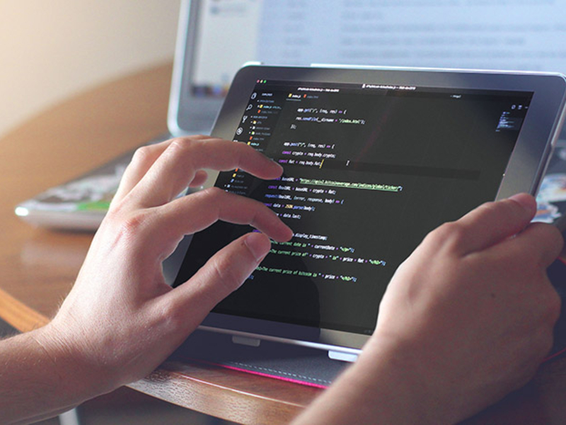 Student working with code on a tablet.