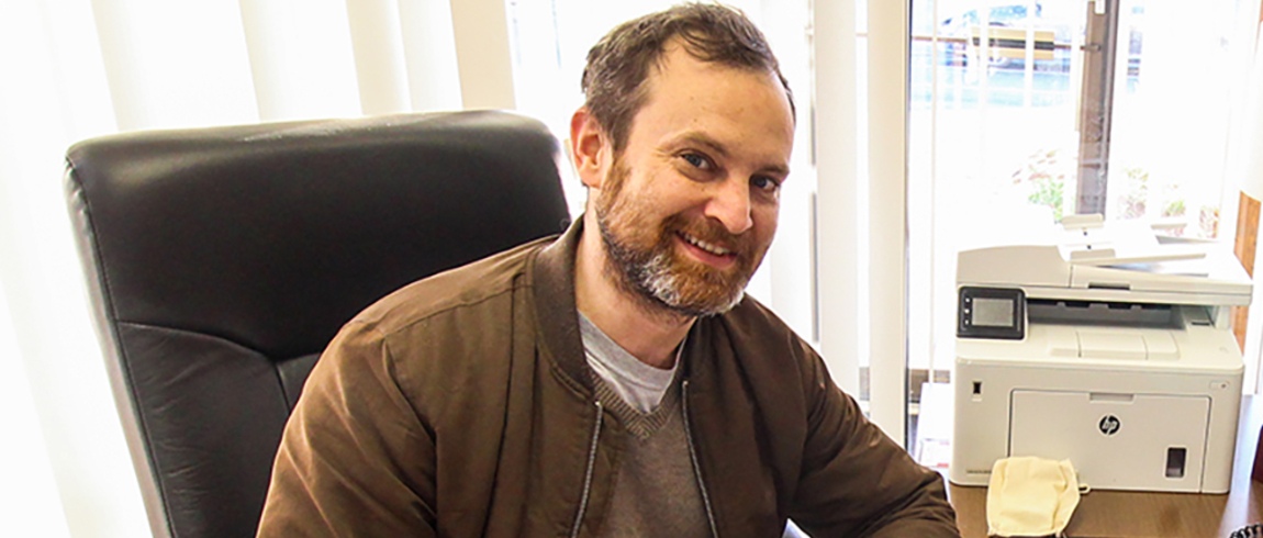 Jeremy Bishop, pictured here at his desk at Carol's Hope, is one of more than 200 LMC students accepted into the Futures for Frontliners program. Futures for Frontliners