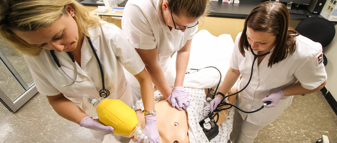 Nursing students practice CPR during class