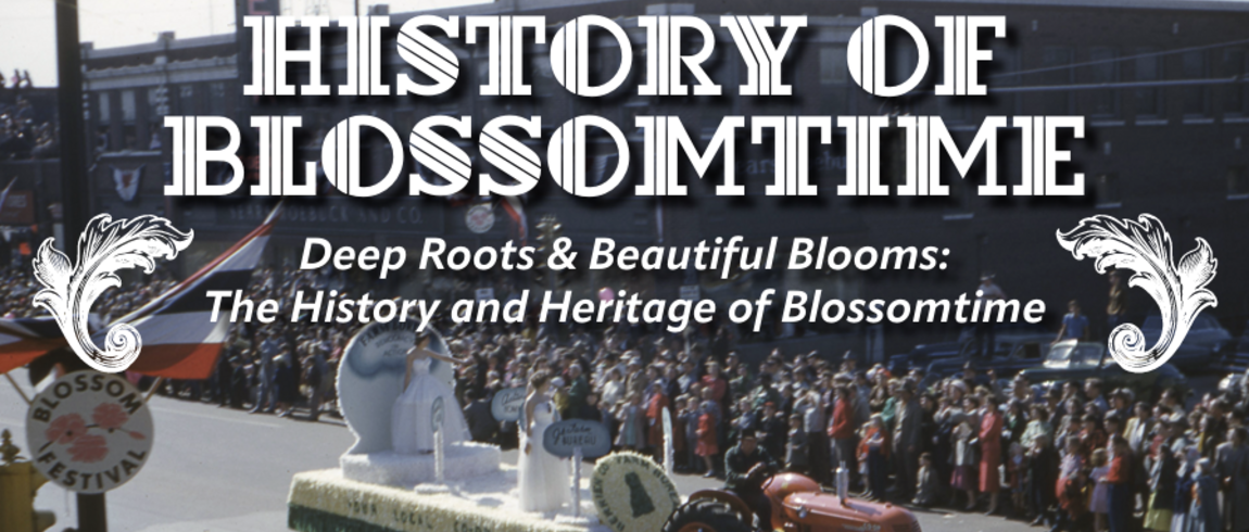 Decorative title slide reading “History of Blossomtime: Deep Roots & Beautiful Blooms—The History and Heritage of Blossomtime” over a vintage photo of a parade. A tractor pulls a flower-covered float past large crowds lining a downtown street, with ornate floral graphics on each side of the title.