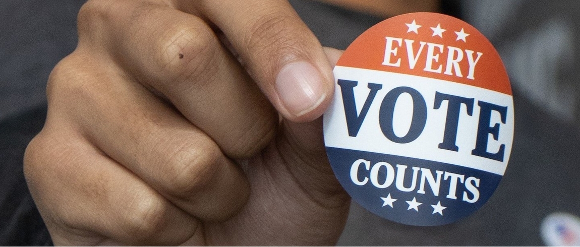 Hand holding "Every Vote Counts" sticker