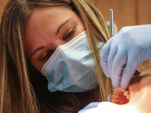 Dental assisting student working on a mannequin