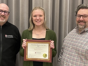 Lake Michigan College Music Faculty Dr. Robert Lunn, left, and Charles Reid, right, pose with Madelyn Ostenson, who was selected as the 2023 Outstanding Musician of the Year.