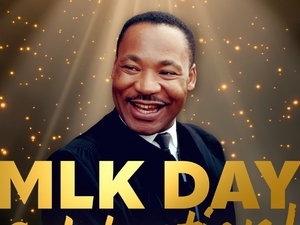 Portrait of a smiling Dr. Martin Luther King, Jr. in a dark suit against a glowing gold, star-like background, with large gold text reading "MLK Day.”
