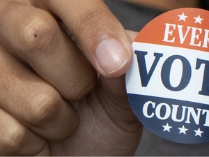 Hand holding "Every Vote Counts" sticker